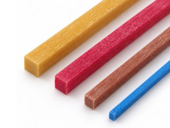 Close-up of the square ends and ceramic-fibre texture of yellow, red, light brown and blue mini polishing stones.