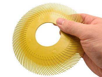 Dedeco Sunburst 6 inch TC radial bristle disc held by hand to show scale and 2 inch centre hole