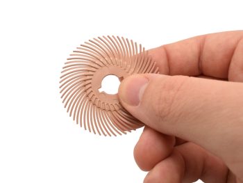 2 inch Dedeco Sunburst TC radial disc held by hand to show scale and flexible bristle design