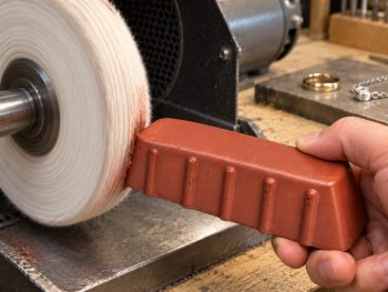 Red Admiral rouge bar being applied to a soft cotton polishing mop