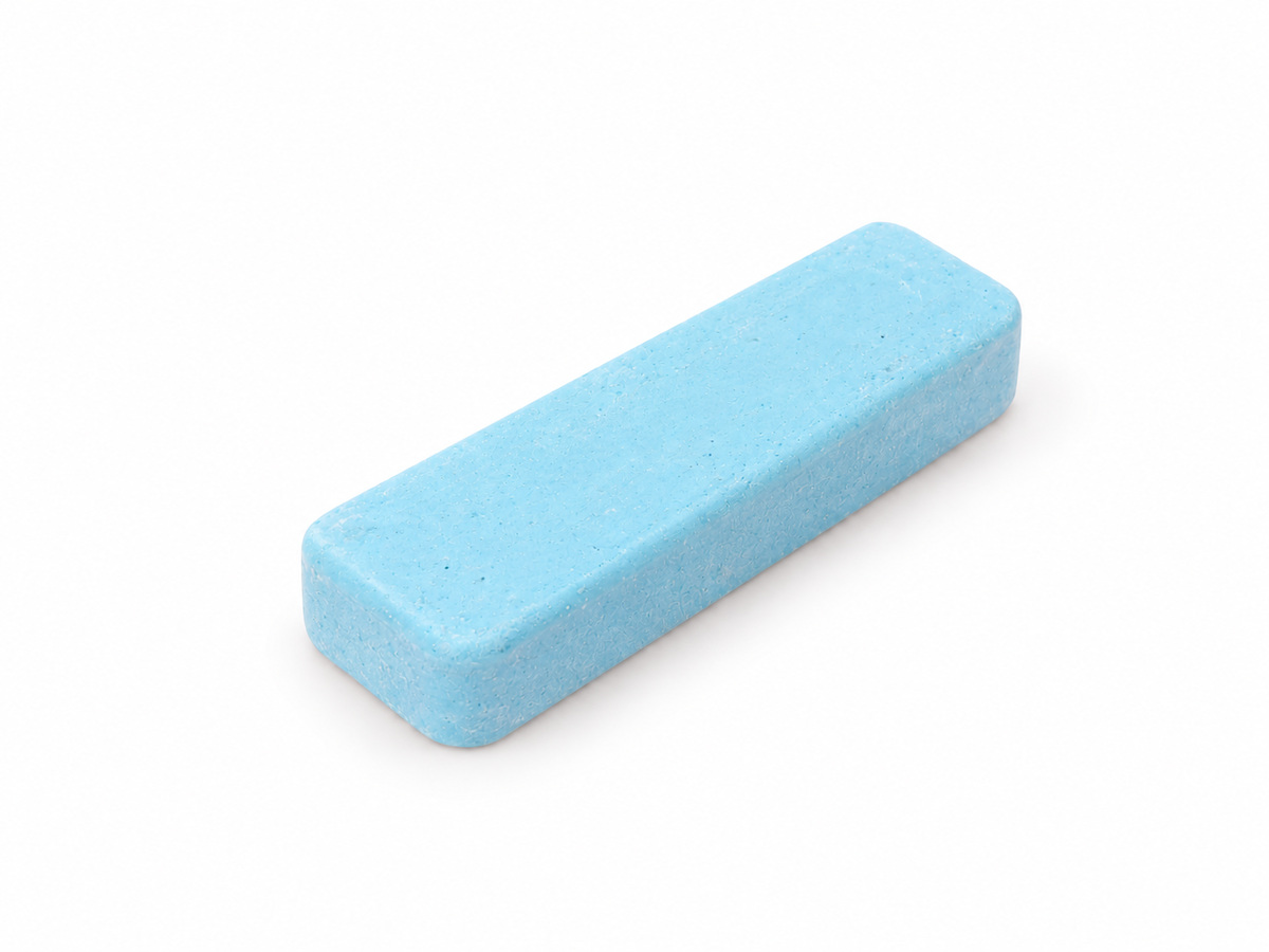 Small 4 x 1 inch blue Blumax polishing compound bar on a white background.