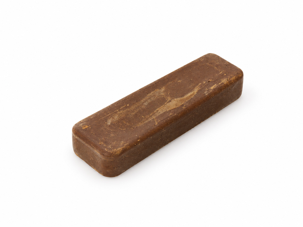 Small 4 x 1 inch brown Tripmax polishing compound bar on a white background.